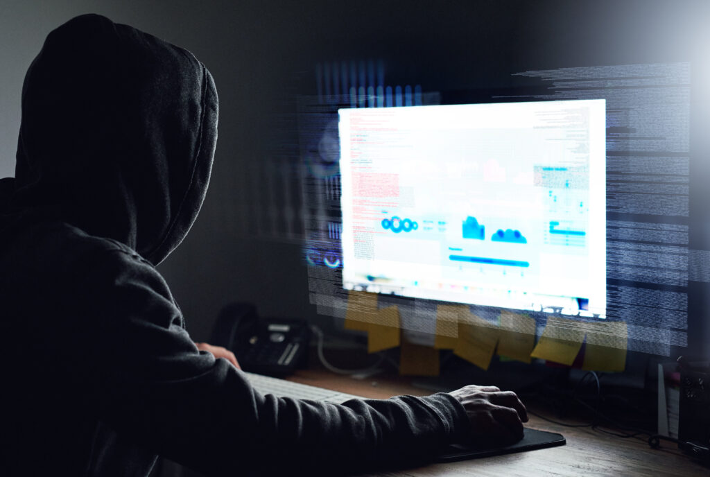Rearview of STIGroup programmer working on cybersecurity systems late at night